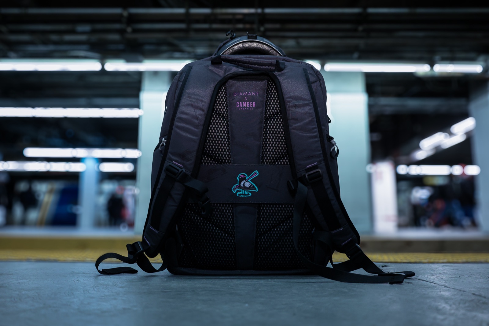 Diamant x Camber Creative branded backpack at a train station