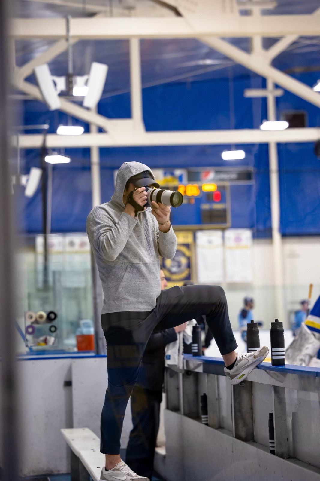 Trevor Earley photographing rink-side during a hockey game
