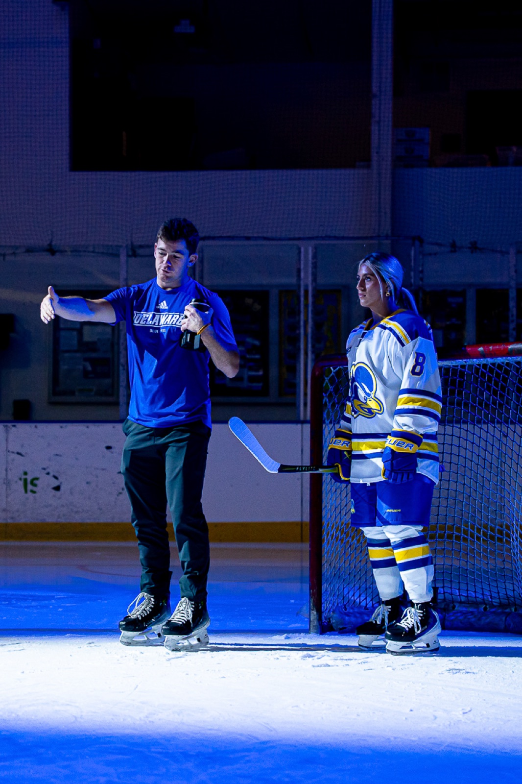 Trevor Earley directing a portrait session on the ice with a University of Delaware hockey player