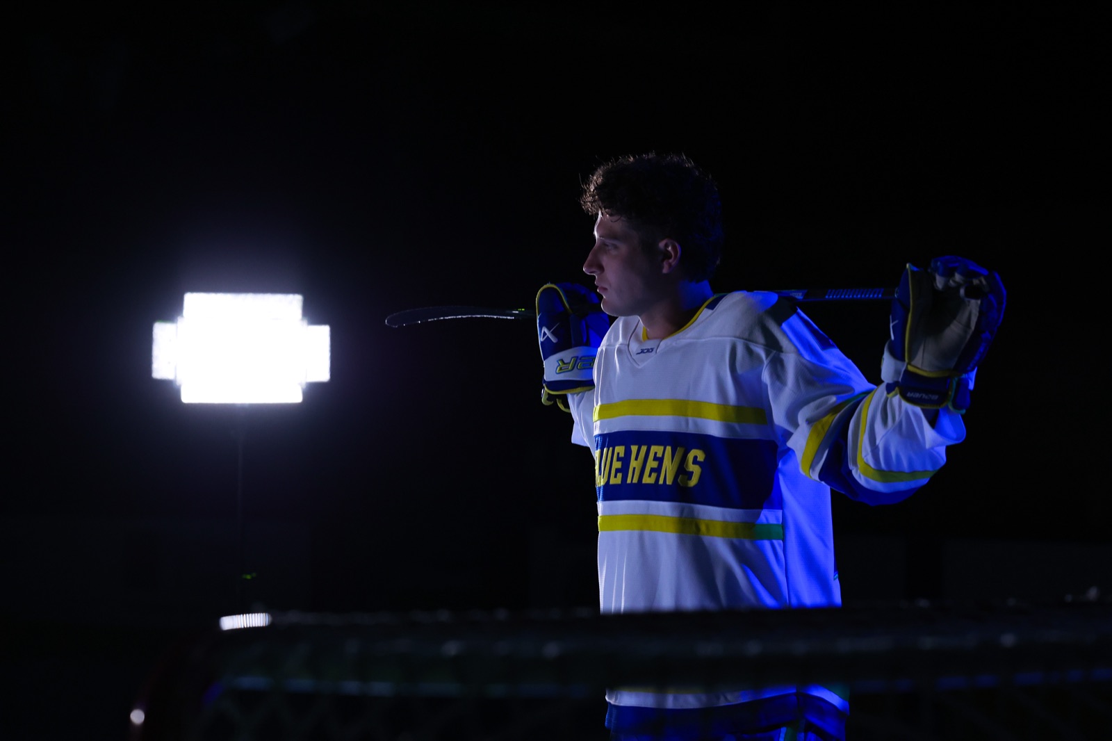 Delaware Blue Hens hockey player in dramatic rim light at media day